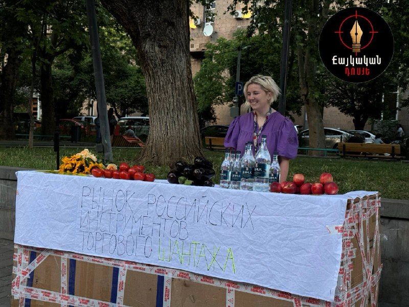 Ироничная инсталляция на Вернисаже в Ереване с помидорами, баклажанами, цветами и бутылками «Джермука» на тему торгового